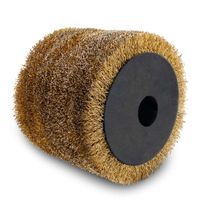 Metal wire brush with black center and gold-brown bristles, photographed from above.