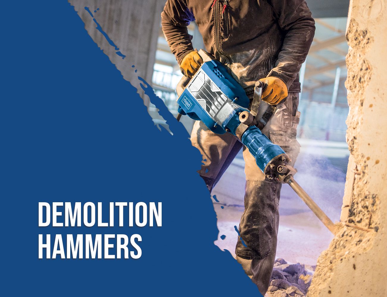 A worker uses a Scheppach demolition hammer to demolish a wall. The hammer is a robust tool for breaking down structures.
