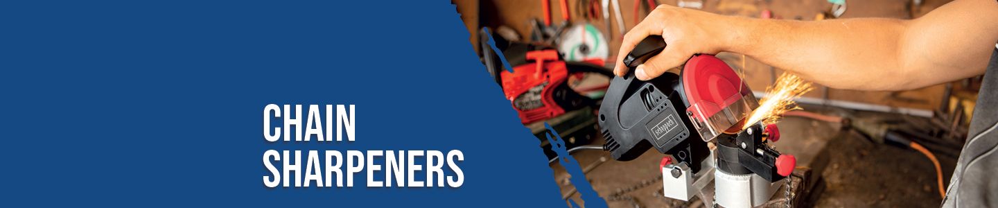 A man is sharpening a chainsaw with a Scheppach chain sharpener. Sparks fly as he holds the handle of the tool. Other tools are visible in the background.