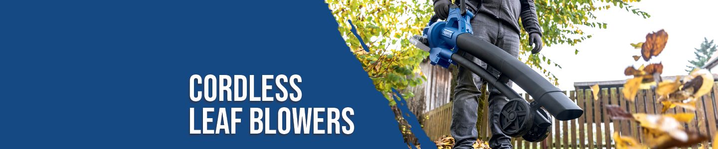 Person using a cordless leaf blower in the garden. Leaves flying through the air. Scheppach shop for cordless leaf blowers.