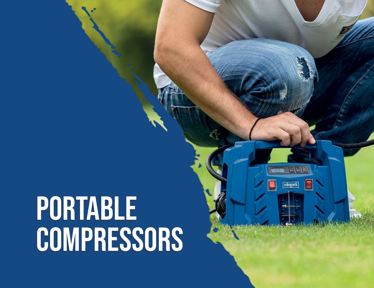 A man is kneeling on the ground operating a portable compressor by Scheppach. The compressor features a digital display and several control buttons. The scene takes place on a green lawn.