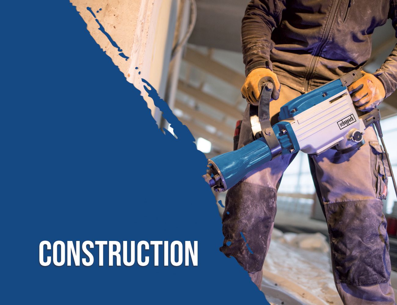 A worker holds a Scheppach tool, possibly an angle grinder, while working at a construction site. The focus is on the tool and the worker's hand.