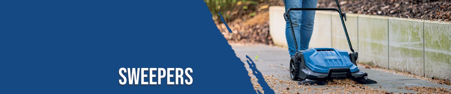 A person is using a Scheppach sweeper on a paved path. A fence and a tree are visible in the background.