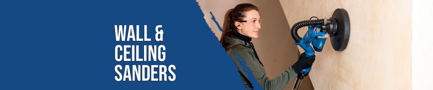 A person is using a Scheppach wall and ceiling sander. The sander has a round sanding pad and a dust extractor attachment.