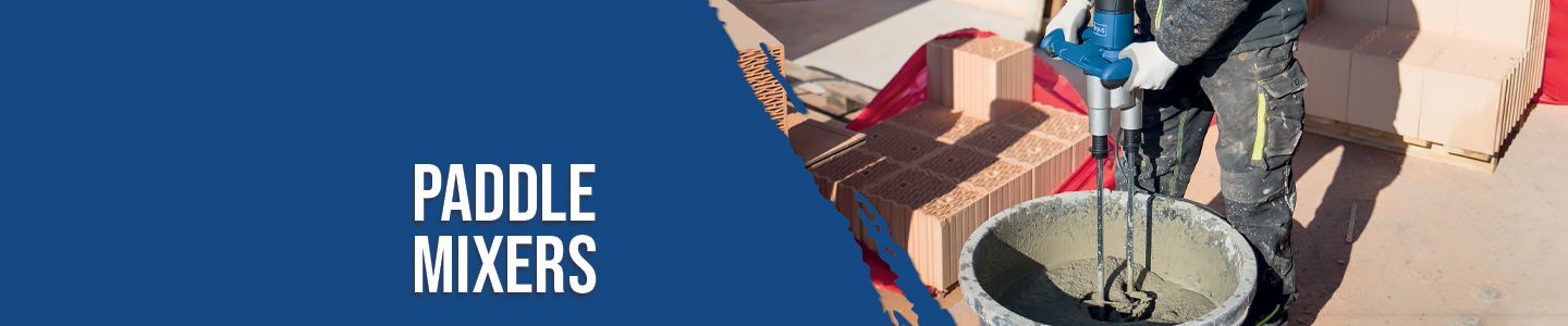A worker uses a Scheppach paddle mixer to mix cement in a bucket. Bricks are stacked in the background.