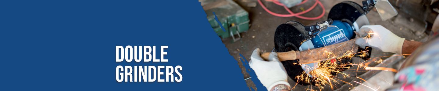 A worker uses a Scheppach double angle grinder. Sparks fly while grinding metal. The grinder is in operation and held safely with gloves.