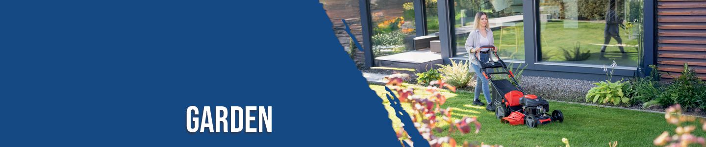 A person is mowing the lawn with a lawnmower in front of a modern house. The garden is well-maintained with various plants and flowers.