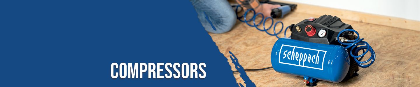 Scheppach compressor on a wooden floor. Tools and hoses are visible in the background.