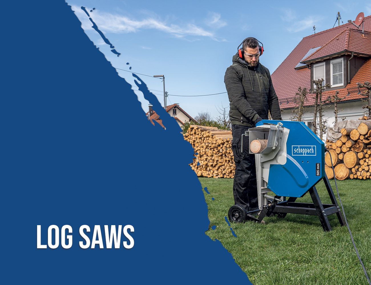 A man operates a Scheppach log saw outdoors. In the background, there are stacks of wood and a house.