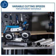 Variable cutting speeds metal band saw with cutting blades and material samples on workbench