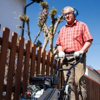 Man operating a Scheppach vibrating plate compactor outdoors