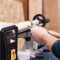 Scheppach lathe machine with workpiece clamp during woodworking process