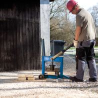 Scheppach HSC130 stone splitter in use with operator handling
