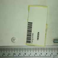 Fixing screw, photographed from above, with product label and ruler in the background.
