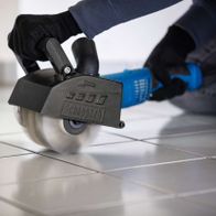 Scheppach plastic fiber brush in use, with control handle and protective gloves