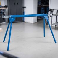 Adjustable stand with height-adjustable legs and crossbar for precise machine support