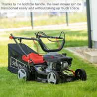 Scheppach petrol lawn mower with foldable handle, lying on grass