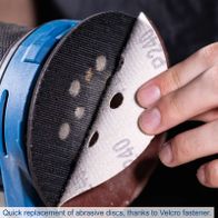 Quick replacement abrasive disc with Velcro attachment for cordless orbital sander