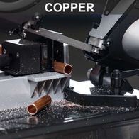 Metal band saw with worn copper band and saw blade, depicting cutting action