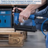 Nail and stapling tool with large compressed air tank for extended operation shown in use