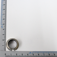Slide bush Permaglide® PAF 15090 P10 with a ruler in the background. The slide bush is viewed from above.