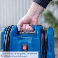 Portable compressor with tire inflator and accessories, featuring a mobile setup