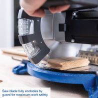 Safety guard enclosing saw blade for maximum work safety