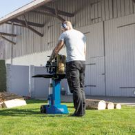 Scheppach HL810 vertical log splitter in use with wood pile and tool setup