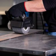 Scheppach silicon carbide brush actively used on metal surface