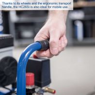 Hand-operated compressor with ergonomic handle and wheels for easy mobility