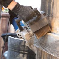 Scheppach abrasive strap brush in use on wooden material