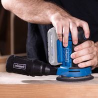 Scheppach cordless orbital sander with attached disc and grip, close-up of operation