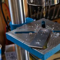 Scheppach bench pillar drill in operation with chuck and workpiece clamp