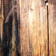 Wood grain with natural cracks and wear marks, typical of Scheppach tools