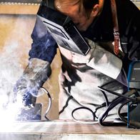 Welder operating Scheppach WSE4000 multi-purpose welding machine during a welding process