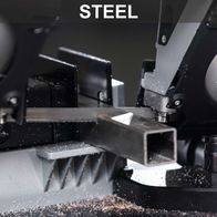 Metal band saw with worktable and LED lighting, showing cutting mechanism detail