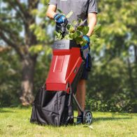 Electric garden shredder with 45L bag and 10m cable, shown in use with collected branches