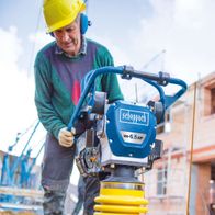 Scheppach petrol-powered vibrating tamper with transport wheels, construction site use