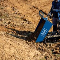 Scheppach dumper with bucket for transporting soil, operating on open terrain