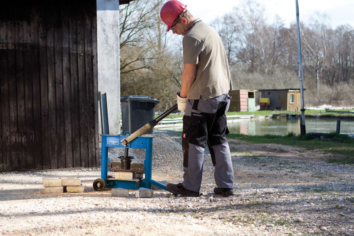Scheppach HSC130 stone splitter in use with operator handling