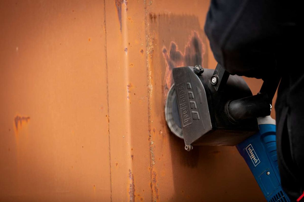 Scheppach metal wire brush in use on a surface