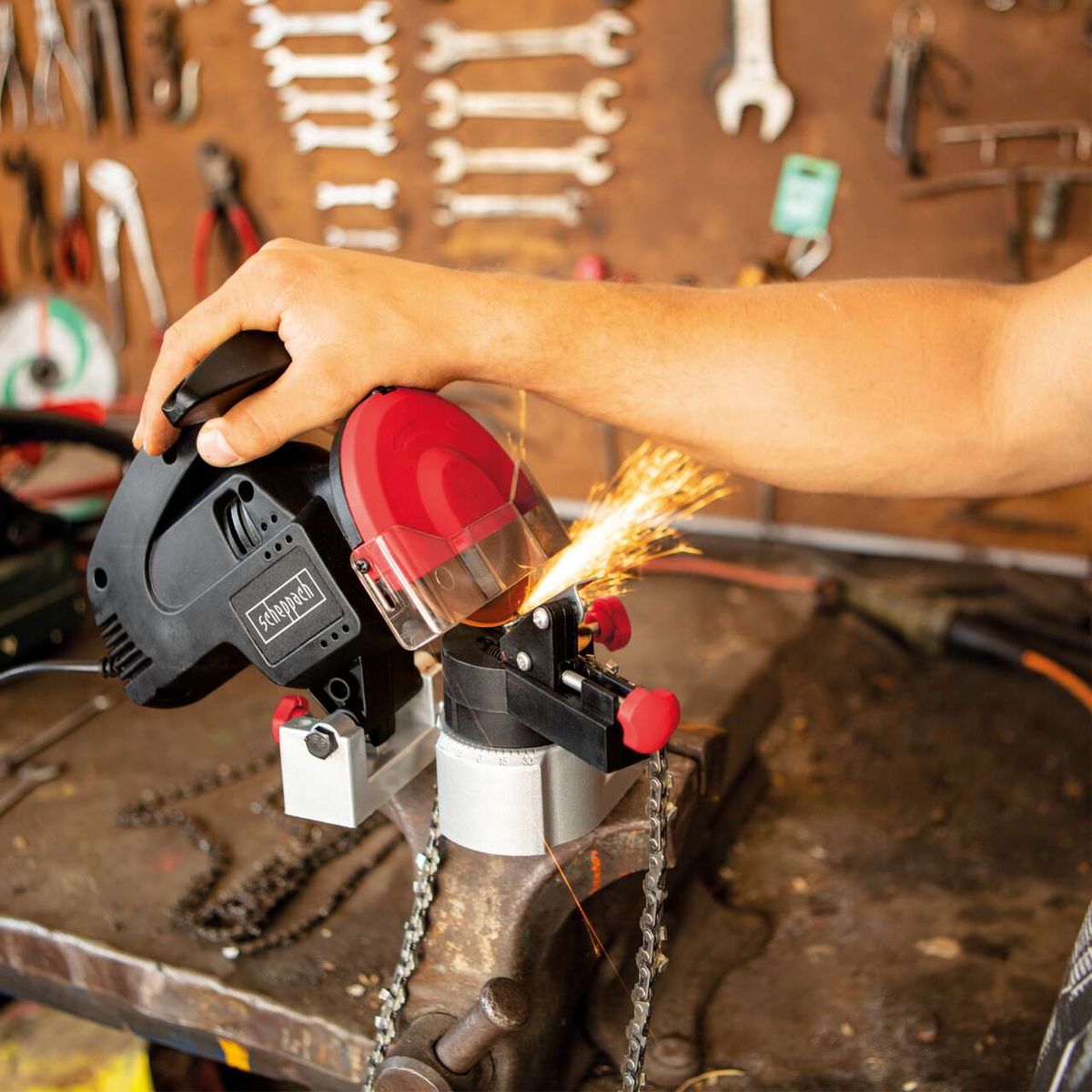 Chain sharpener with spark screen and protective glass, cutting detail shown