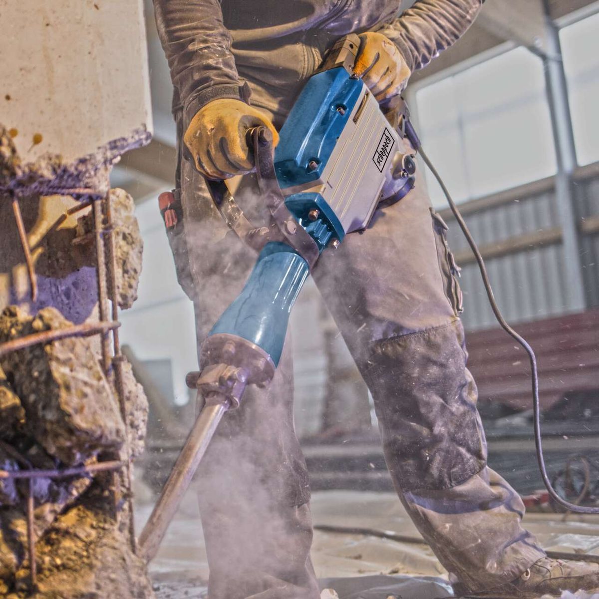 Scheppach demolition hammer with anti-vibration handle and SDS-Max impact system in use