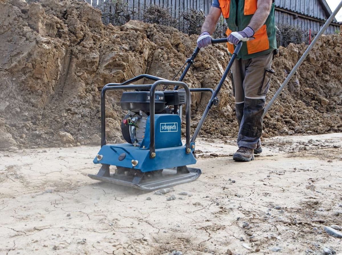 Scheppach vibrating plate with base and wheels in use on a work surface