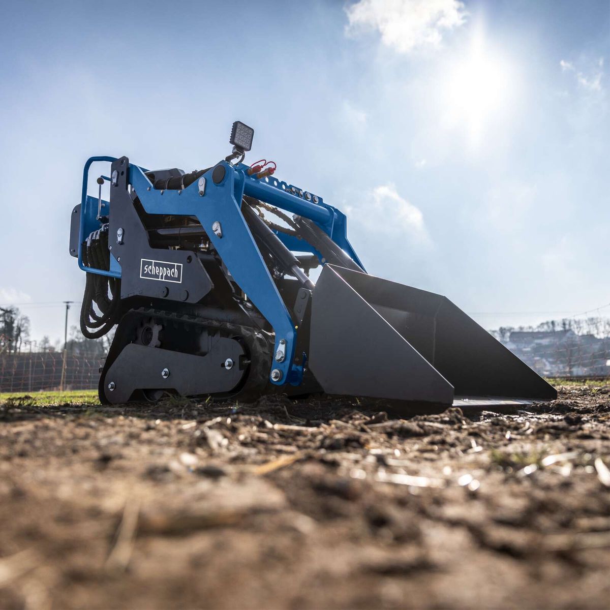 Scheppach compact loader with integrated bucket, featuring an electric start for light earthwork and material handling