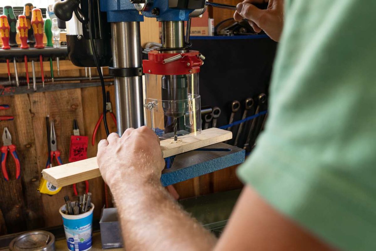 Scheppach bench pillar drill with laser guide, operating on workpiece