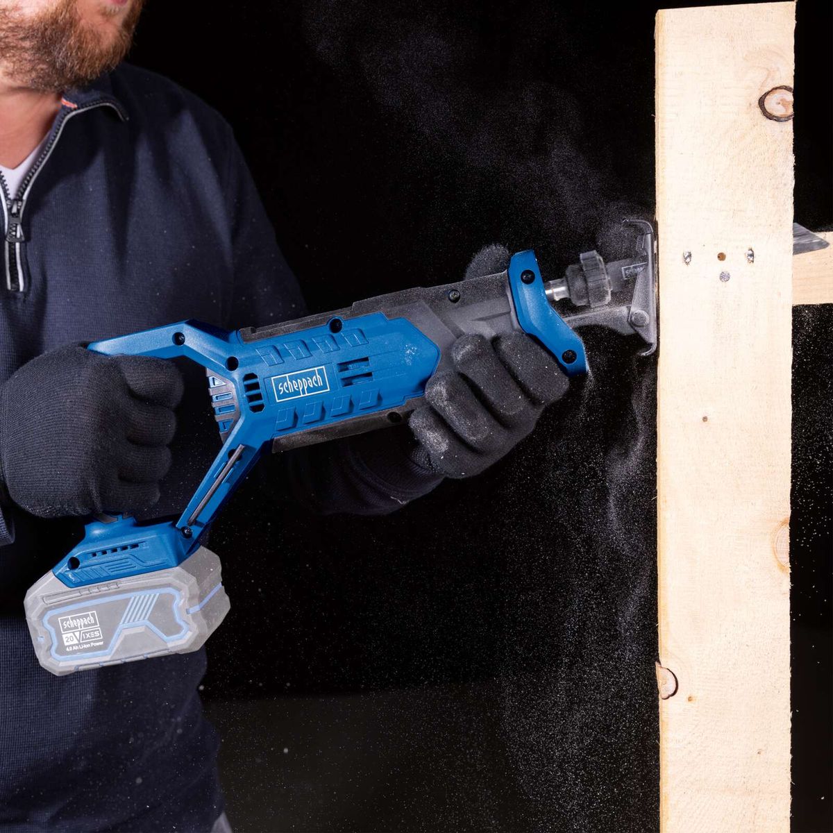Scheppach cordless reciprocating saw with LED display and battery holder, in use