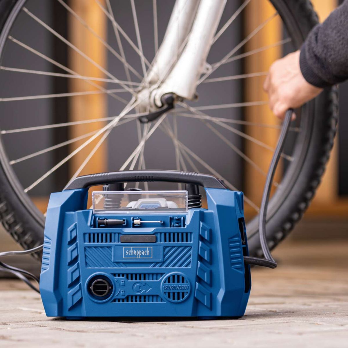 Scheppach cordless hybrid compressor with USB ports and multiple drive options, showing key features like display and valve connections