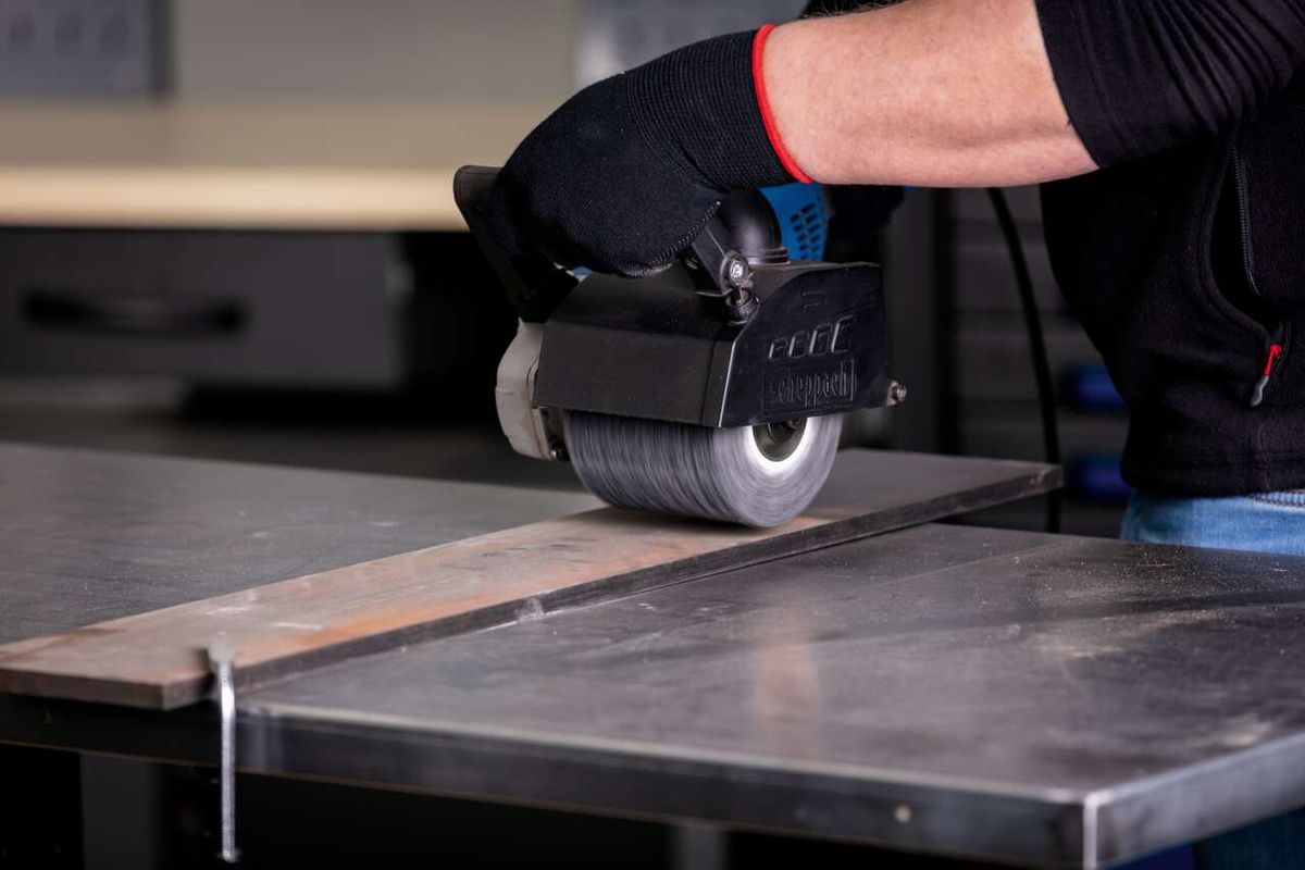 Scheppach silicon carbide brush actively used on metal surface