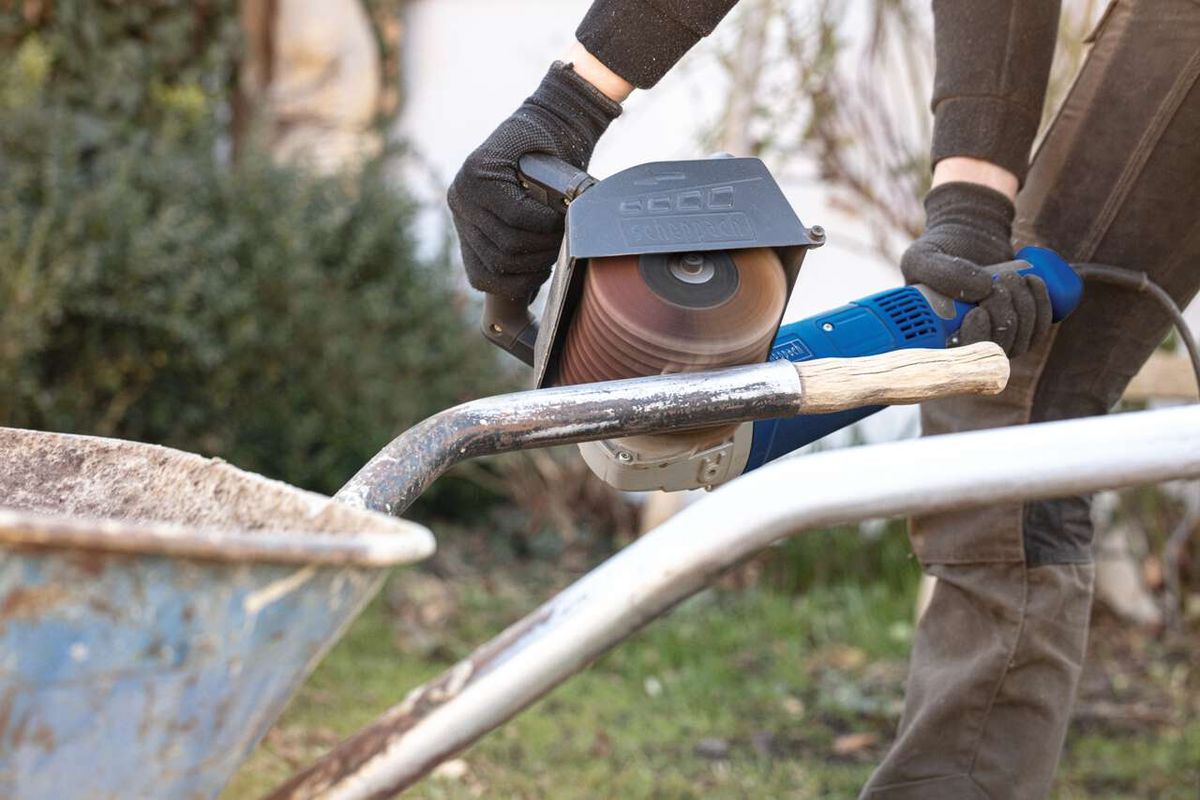 Person using an abrasive strap brush from Scheppach